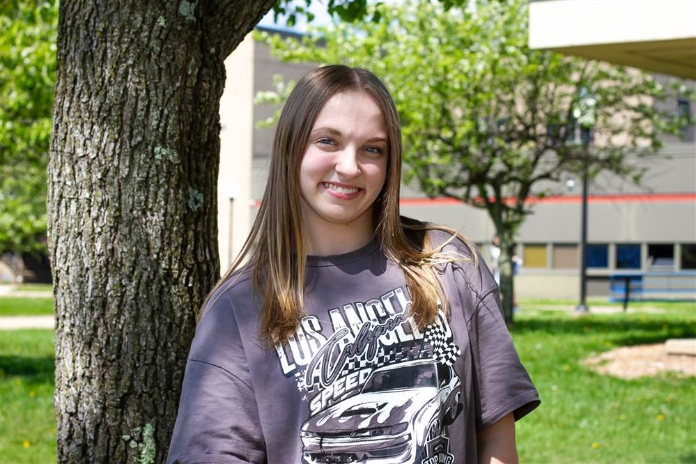  Photo of Addison in front of a tree